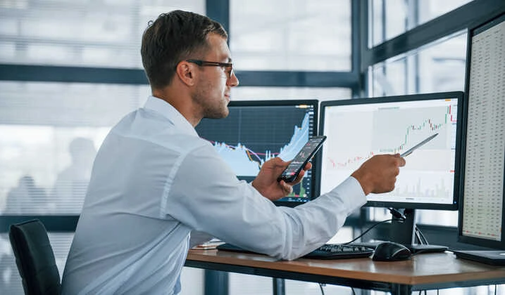 Day trader analyzing a candlestick chart on a trading platform Day trader analyzing a candlestick chart on a trading platform